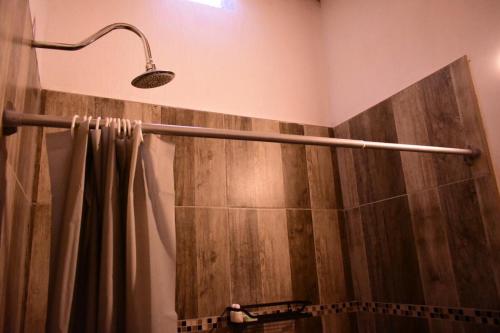 a shower with a shower curtain in a bathroom at Casa Bravía - Hotel·RV in San Luis Soyatlán