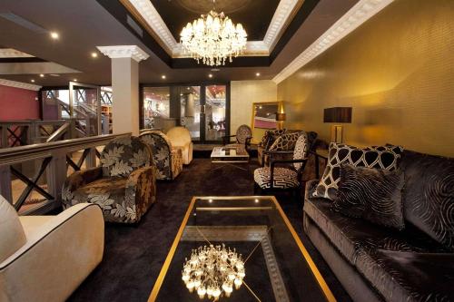 a living room with couches and a chandelier at St James Hotel; BW Premier Collection in Nottingham