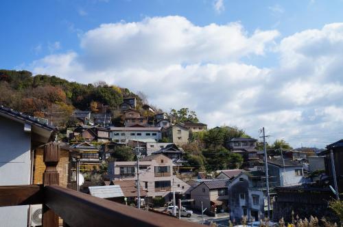 a town on top of a hill with houses at Moon's Cafe in Onomichi