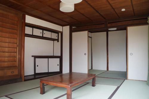 a room with a wooden table and a door at Moon's Cafe in Onomichi