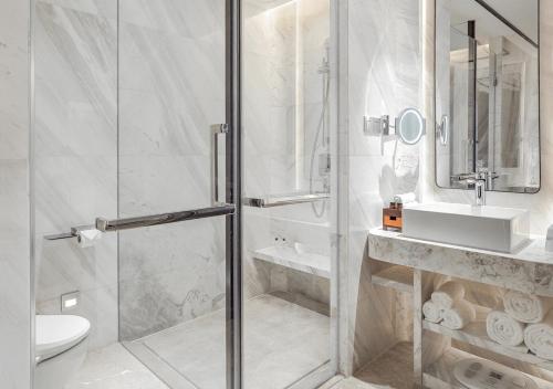 a bathroom with a shower and a toilet and a sink at FlyZoo Hotel - Alibaba Future Hotel in Hangzhou