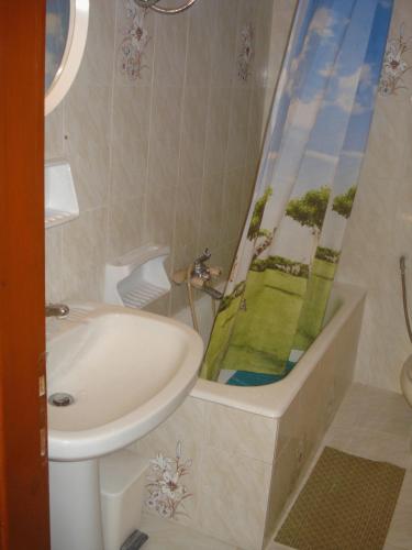 a bathroom with a sink and a tub and a shower at Georgina Apartments-pool-river in Mesongi