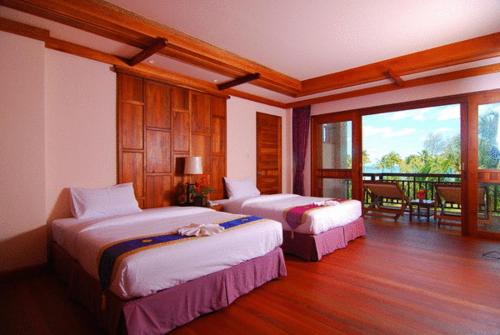 Postel nebo postele na pokoji v ubytování Andamania Beach Resort, Khaolak - SHA plus