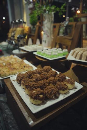 a table topped with plates of food on a table at Ayani Hotel Banda Aceh in Banda Aceh