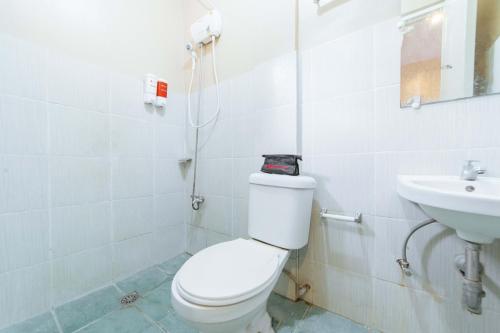a bathroom with a toilet and a sink at RedDoorz @ Lagao General Santos in General Santos
