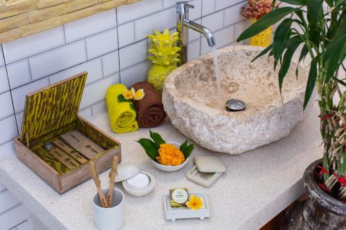 a bathroom counter with a sink on a counter at MasBro ART Villas in Seminyak