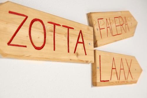 a wooden block with the wordarma written on it at Arena Lodge in Flims