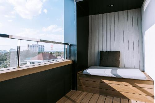 a bedroom with a bed and a large window at The Rich Hotel in Nakhon Ratchasima