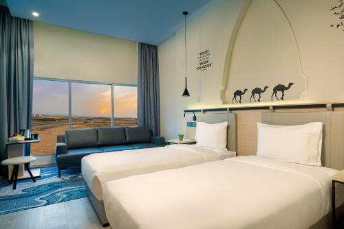 Ένα ή περισσότερα κρεβάτια σε δωμάτιο στο Swiss-Belinn Airport Muscat Oman