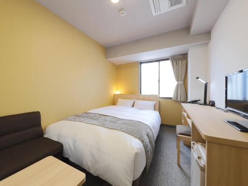 Ліжко або ліжка в номері Matsue Urban Hotel