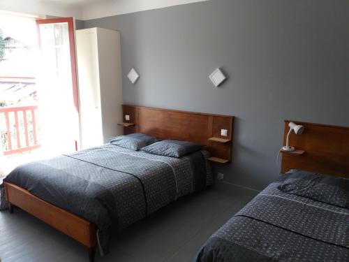 une chambre avec deux lits et une fenêtre dans l'établissement Appts maison Onbor Zilo, à Biriatou