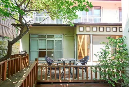 a patio with a table and chairs on a deck at Villa Shibuya in Tokyo