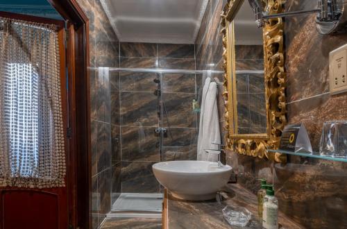 a bathroom with a tub, sink, and toilet at Julina Boutique Living in Mosta