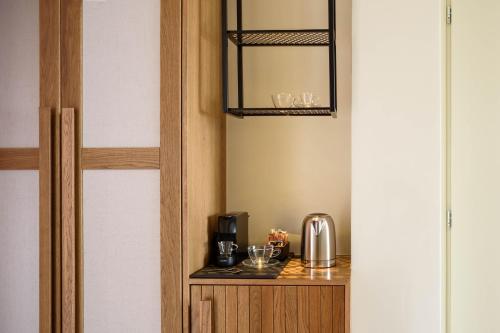 a room with a counter with a coffee maker on it at Potnia Theron Suites in Akrotiri