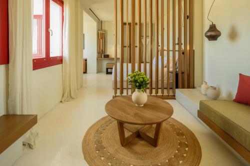a living room with a table and a couch at Potnia Theron Suites in Akrotiri