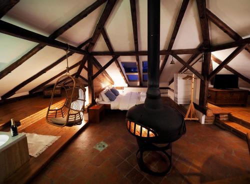 a room with a room with a stove in a attic at Penzion Kamenne Slunce in Telč