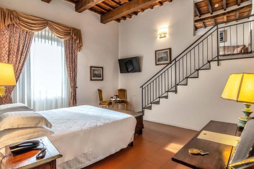 En eller flere senge i et værelse på Hotel Machiavelli Palace