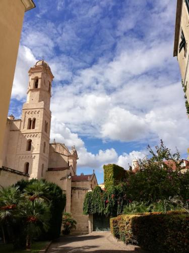a building with a tower with a sky in the background at Domoruja B&B in Sassari