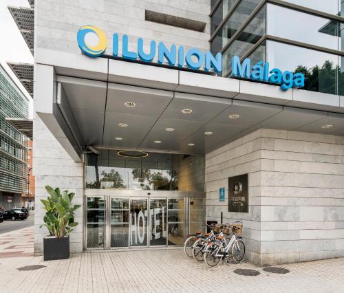 a union malaga building with bikes parked outside of it at Ilunion Málaga in Málaga