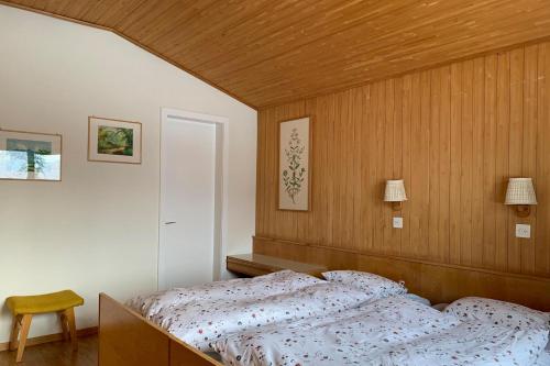 a bedroom with a bed and a wooden wall at La Civetta (714 La) in Valbella
