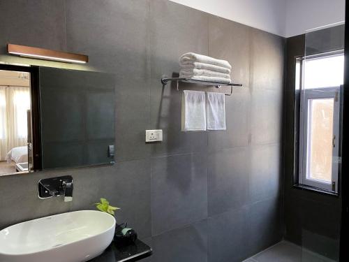 a bathroom with a white sink and a mirror at Kibu Home in Kathmandu