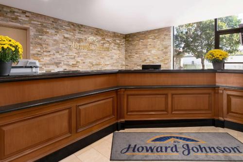 a bar in a restaurant with a sign on the wall at Howard Johnson Plaza by Wyndham Windsor in Windsor