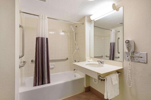 a bathroom with a sink and a tub and a shower at La Quinta Inn by Wyndham Denver Golden in Golden