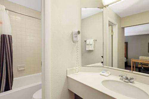 a white bathroom with a sink and a mirror at La Quinta Inn by Wyndham Denver Golden in Golden