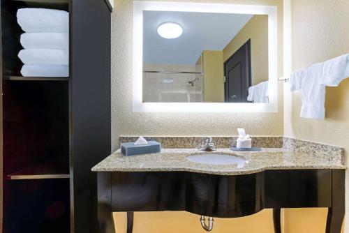 a bathroom with a sink and a large mirror at La Quinta by Wyndham Denver Gateway Park in Denver