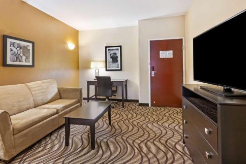 a living room with a couch and a flat screen tv at La Quinta by Wyndham South Bend in South Bend