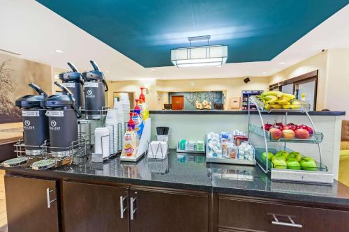 a kitchen with a counter with fruits and vegetables on it at La Quinta by Wyndham South Bend in South Bend