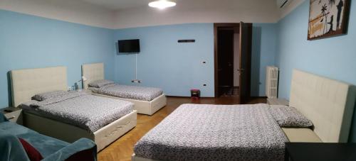 two beds in a room with blue walls at New Life in Mestre