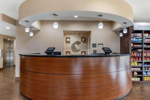a lobby of a pharmacy with a large wooden counter at Comfort Suites Pelham Hoover I-65 in Pelham