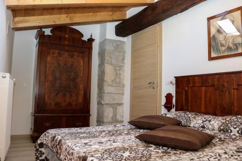 a bedroom with a bed with two pillows on it at Casa del Castagno in Pulfero