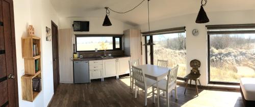 a kitchen and dining room with a table and chairs at SKY Ranch in Izborsk