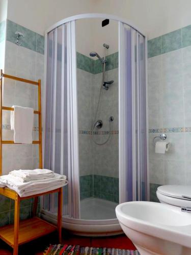 a bathroom with a shower and a toilet and a sink at B&B Porta del Re in Taormina