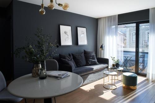 a living room with a couch and a table at Nôma Living Pop Saldanha in Lisbon