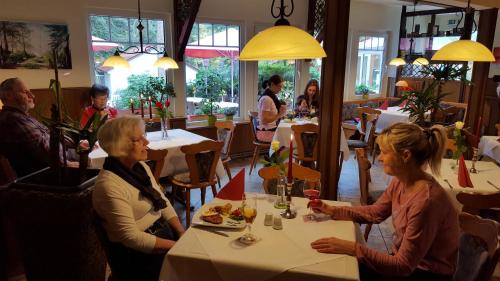 two women sitting at a table in a restaurant at Hostel Schweriner See in Retgendorf