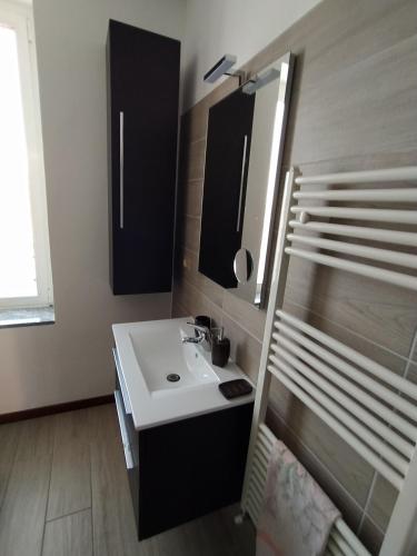 a bathroom with a sink and a mirror at PINK & GREEN APARTMENTS - RHO FIERA MILANO MIND - Andrea in Rho