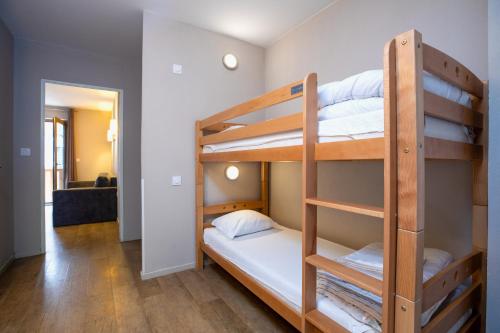 a room with three bunk beds in a room at SOWELL RESIDENCES Pra Loup in Pra-Loup