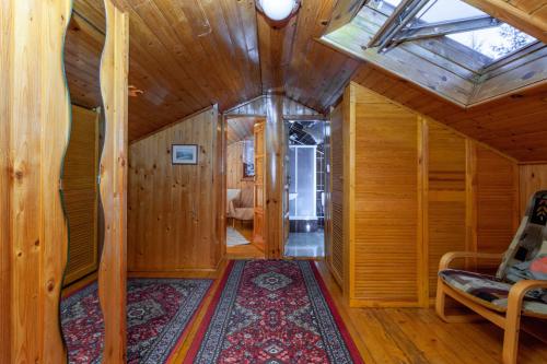 a room with wooden walls and a ceiling with a skylight at Goralturist in Ždiar