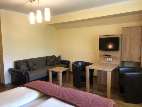 a living room with a couch and a tv at Frühstückspension Porranzl in Hofamt Priel