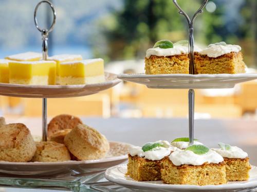 a table with three tiers of cakes and pastries at Hotel Alto Traful in Villa Traful