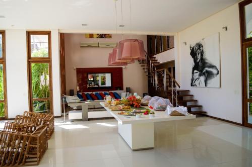 a kitchen and living room with a table and chairs at Refúgios Parajuru in Parajuru
