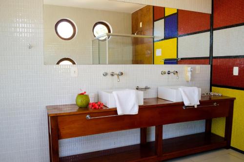 La salle de bains est pourvue de 2 lavabos et d'un miroir. dans l'établissement Refúgios Parajuru, à Parajuru