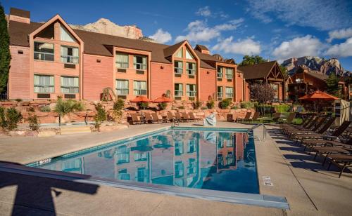 a large building with a swimming pool in front of it at Holiday Inn Express Springdale - Zion National Park Area, an IHG Hotel in Springdale