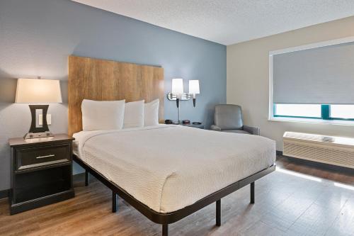 a hotel room with a large bed and a large window at Extended Stay America Premier Suites - San Jose - Airport in San Jose
