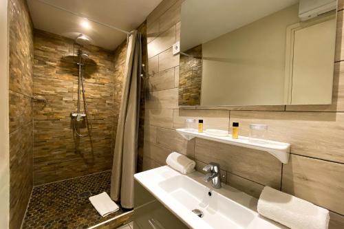 a bathroom with a sink and a shower at Le Magnan in Avignon