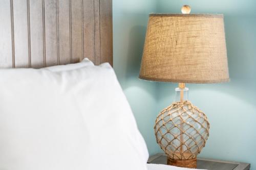 a lamp on a night stand next to a bed at Rainbow Bend Resort in Marathon