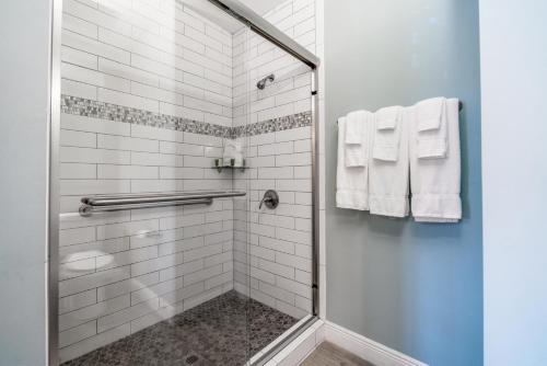 a bathroom with a shower with white tiles at Rainbow Bend Resort in Marathon